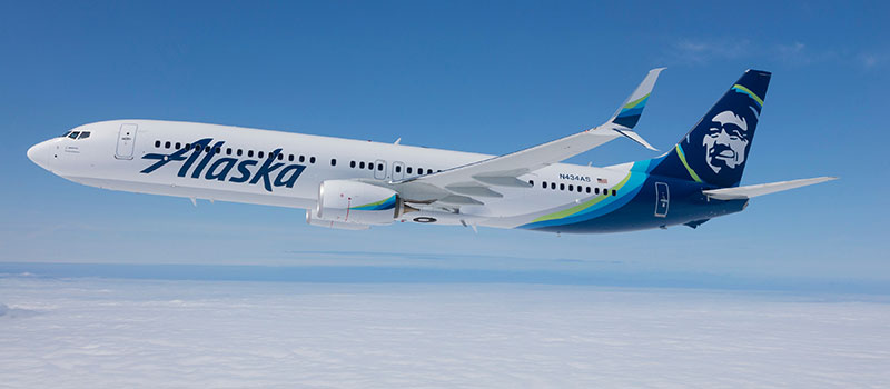 Alaska Airlines plane in blue sky