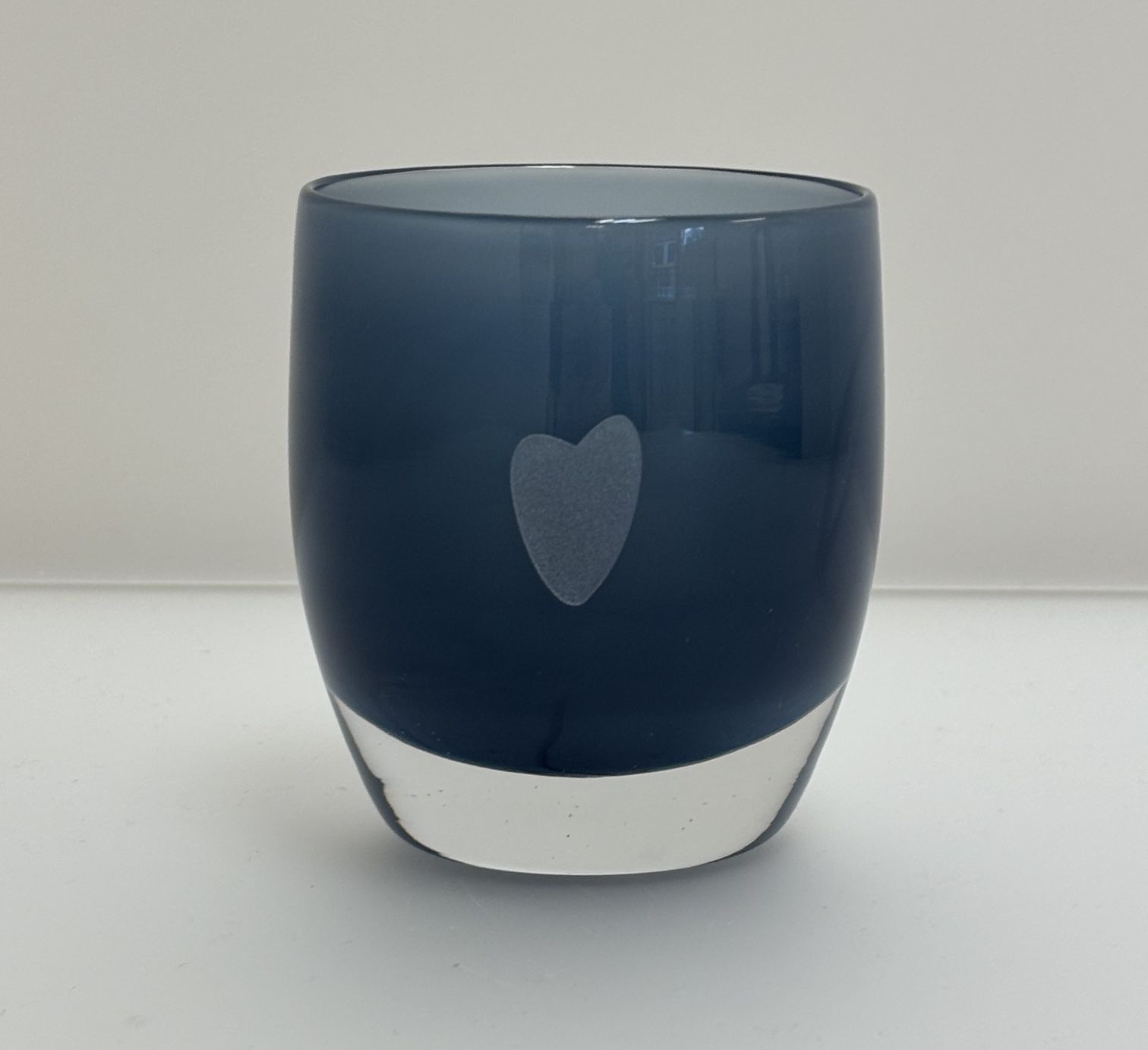Image of a soft blue glassybaby candle votive engraved with the "Korey heart" design.